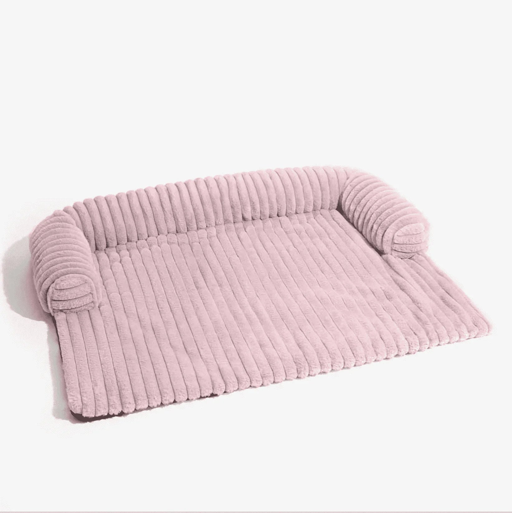 Roze hondenmand voor de bank