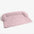 Roze hondenmand voor de bank